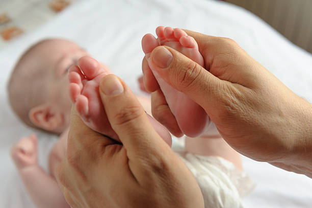 Baby feet massage stock photo