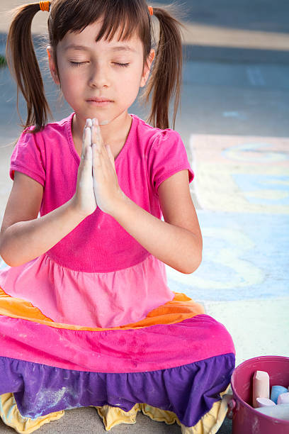 istock Young girl sitting and meditating 185236035