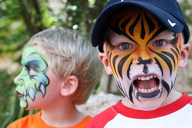 Face Painted Children Boys with painted faces. cat face paint stock pictures, royalty-free photos & images