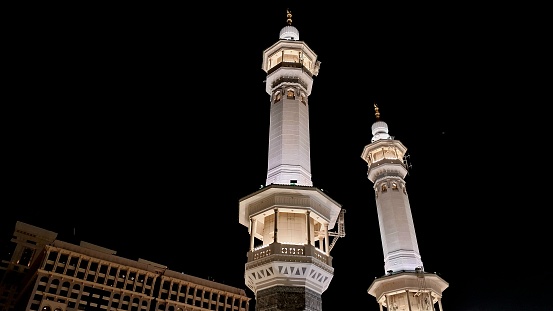 A low angle view of the two beautiful minarets of the Sacred Mosque of Makkah, al-Masjid al-Haram, at night.