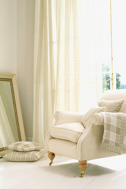 istock Formal white chair next to window with curtain 185236439