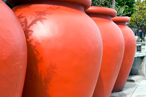 Closeup large round red terracotta pots, full frame horizontal composition