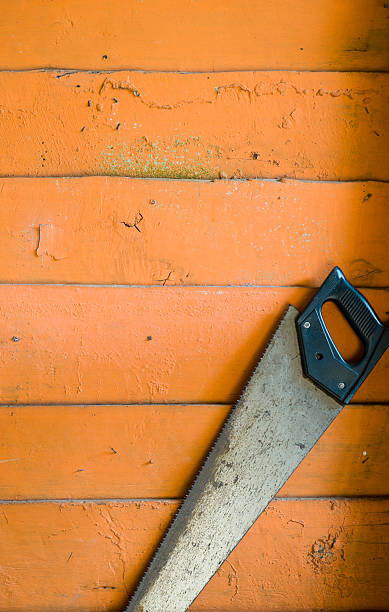 istock Carpenter tool Saw over wood plank. 185237300