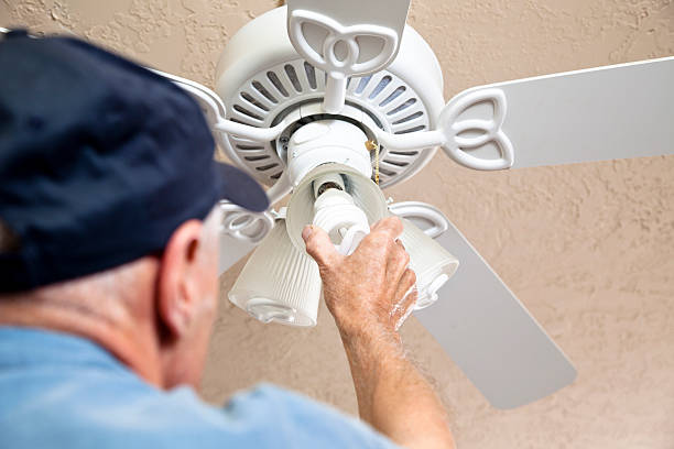 istock Electrician changing out light bulbs to eco-friendly compact fluorescent 185237386