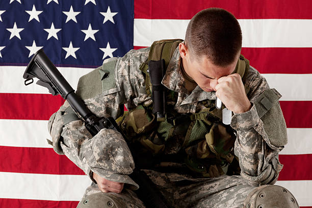 istock Army man sitting in front of an American flag 185237405