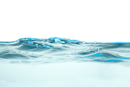 Blue water surface with waves and splashes.