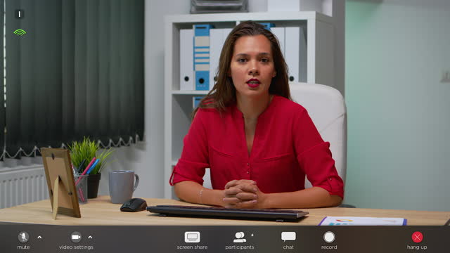 Business woman talking in front of camera during video call