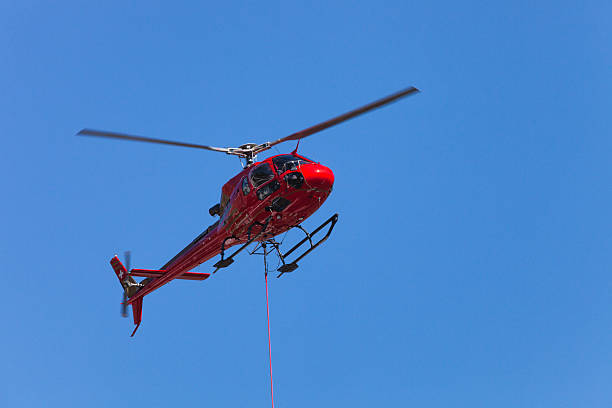 istock Swsis Helicopter lifting load on a cable 185238141