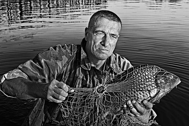 寿命の釣り人 - catch of fish sport black and white activity ストックフォトと画像