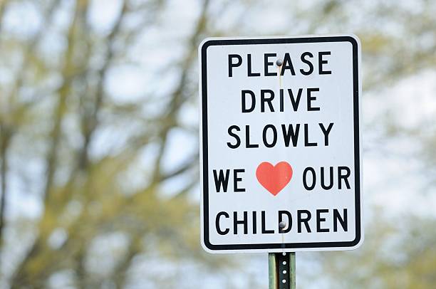 Please drive slowly we lover our children sign stock photo