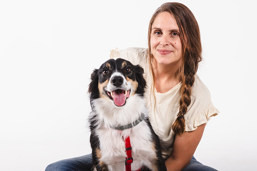 Portrait of a smiling woman looking at camera together with a dog