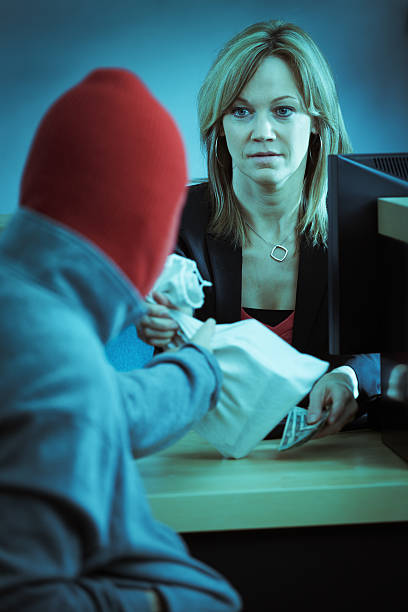 Bank Robber in Action Robbing Retail Banking Counter