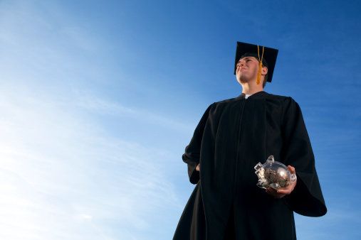 This is a photo of a college graduate holding a piggy bank. There is a lot of space for copy on the left.click on the links below to view lightboxes.