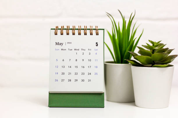 istock Desk calendar for May 2024 on a green background. 1852393076