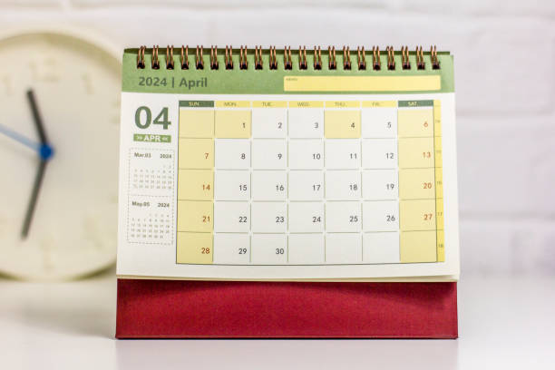 istock Desk calendar for April 2024 and a clock on the table. 1852393607