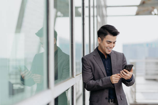 istock Businessman using smartphone on building terrace 1852395799