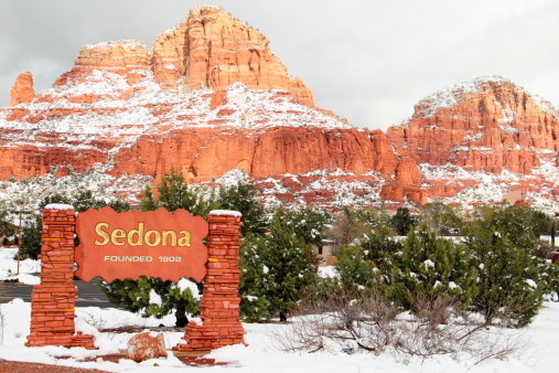 A winter scene at the entrance to Sedona Arizona.  On the right is The Chapel of the Holy Cross which is a Catholic chapel belonging to the Parish of Saint John Vianney and the Roman Catholic Diocese of Phoenix. It was built directly into a butte and offers a spectacular view of the valley 200 feet below. One of most visited churches in Sedona.