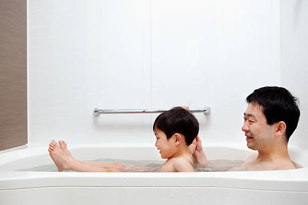 Father and little boy in the bathroom stock photo