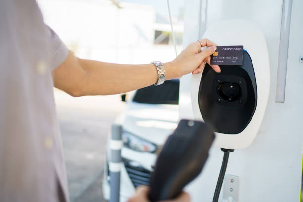 istock Man charging EV car at public charging station. 1852399610