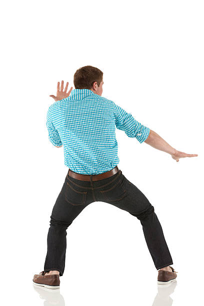 istock Rear view of a man standing in fighting pose 185240024