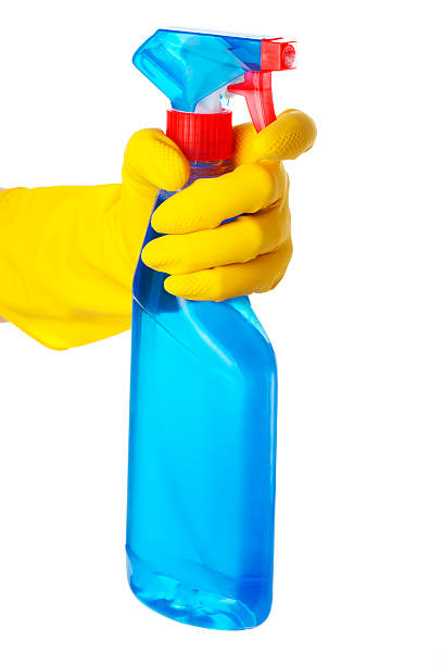 istock Hand in protective glove holding cleaning spray bottle 185240385
