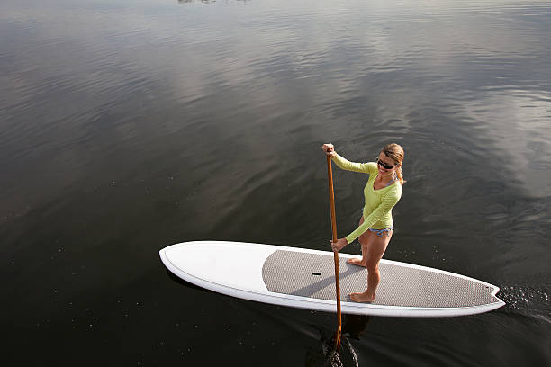 Stand up paddling on a calm lake.