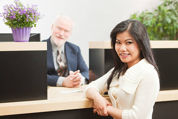 feliz asiática varejo bancos cliente em frente para caixa de banco - bank teller bank check asian ethnicity - fotografias e filmes do acervo