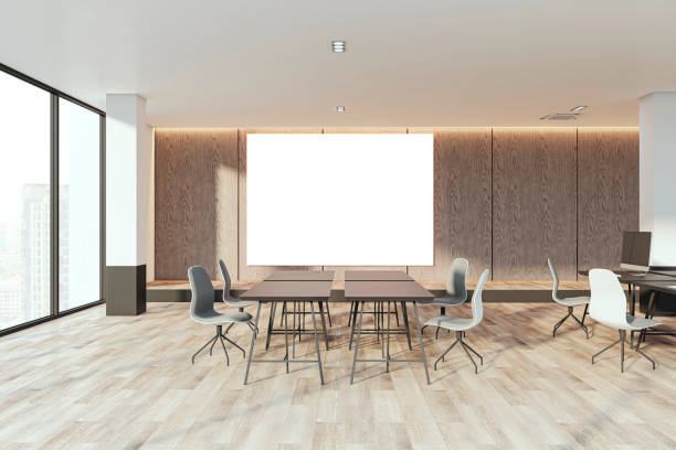 istock Modern coworking office interior with empty white mock up banner, concrete wall, wooden flooring, windows with city view, sunlight, shadows and furniture. 3D Rendering. 1852411669