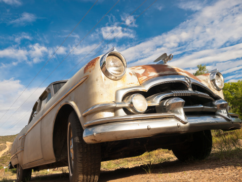 Front view of an classic american old low rider against blue sky.