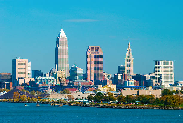 Cleveland skyline and Lake Erie "Downtown Cleveland Skyline prominently portraying Key Tower and Terminal Tower with a bridge, the Cleveland coastline, and with Lake Erie in the Foreground" terminal tower stock pictures, royalty-free photos & images