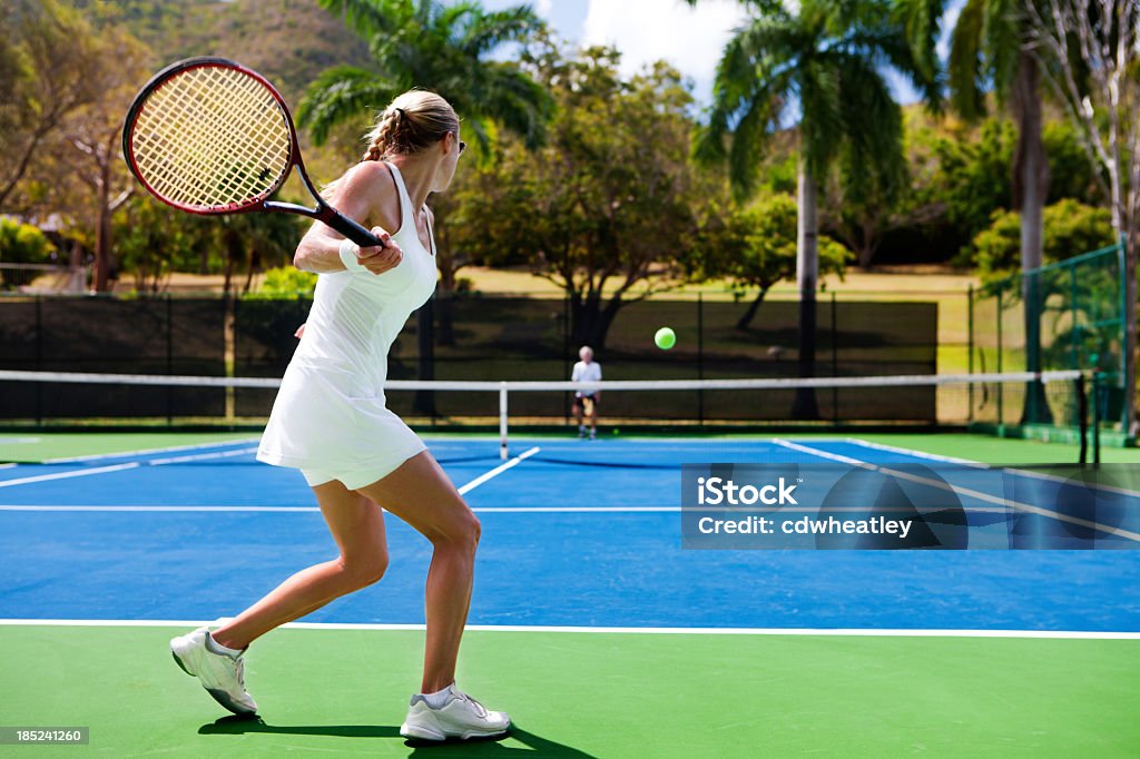 people playing tennis in tropics two people playing tennis in a tropical settingview images from the same series: Tennis Stock Photo