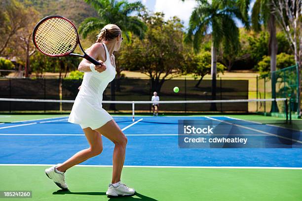 People Playing Tennis In Tropics Stock Photo - Download Image Now - Tennis, Playing, Sports Court