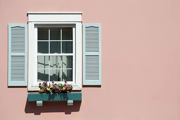 Photo of Window with pink background and windowbox.