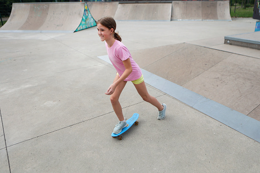 Girl skateboarding. About 12 years old, Caucasian female.