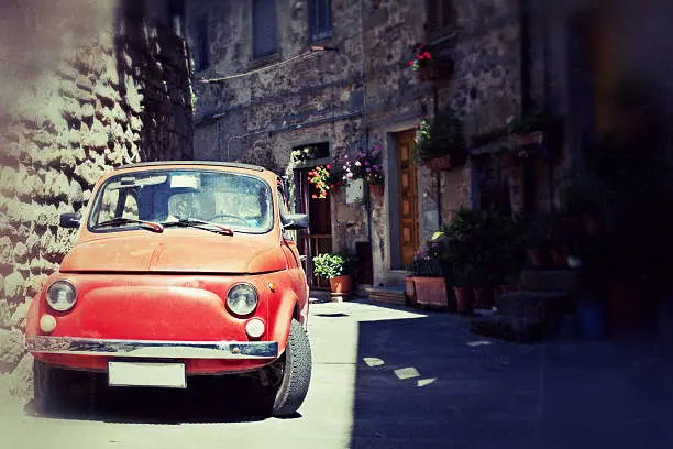 A red the Fiat 500 along the streets of Florence. Vintage effect