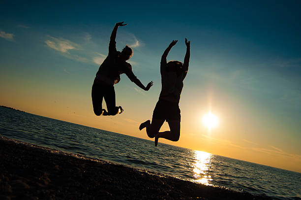 istock Girls Jumping on Beach 185242255