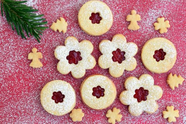 istock Linzer cookies on red sugared background with fir twig 1852424417