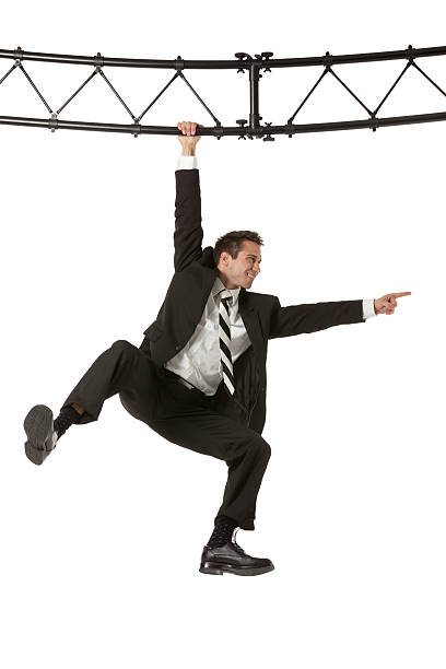 istock Businessman hanging from a metal structure and pointing 185242604