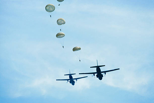 istock Row of parachutists and two airplanes 185242897