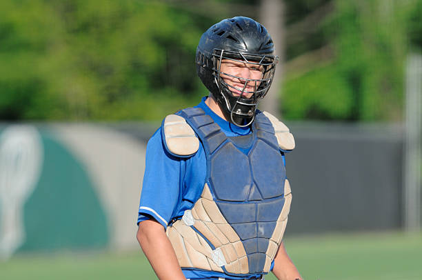 Baseball catcher "Baseball catcher looking into sun, horizontal with copy space." Chest Protector stock pictures, royalty-free photos & images