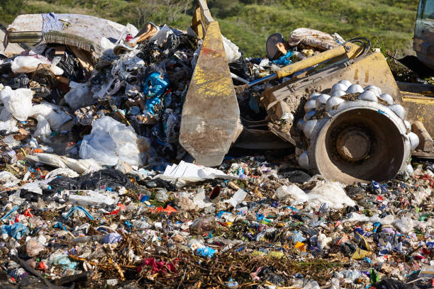 istock Heavy machinery shredding garbage in an open air landfill. Pollution 1852434486