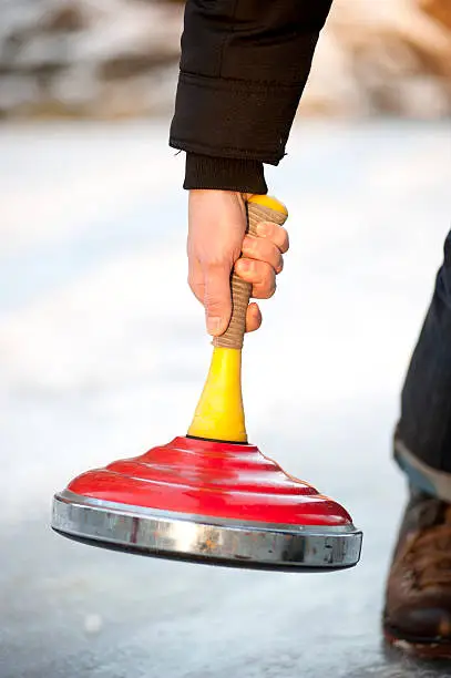 curling on ice outside
