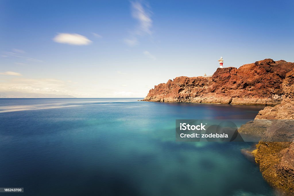 Lighthouse and Ocean in Canary Islands Lighthouse along rocky coast. Tenerife Stock Photo