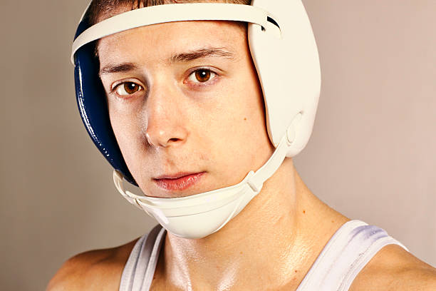 Wrestler Close up of a wrestler wearing head gear. headwear stock pictures, royalty-free photos & images