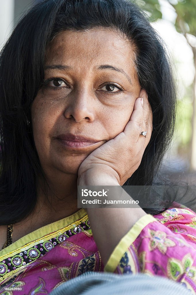 Fifty something woman Pensive Fifty something woman looking at the camera 45-49 Years Stock Photo