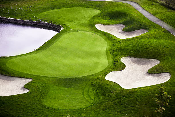 Green golf course aerial view Fairway and sand traps of a green golf course from a bird eye view green golf course stock pictures, royalty-free photos & images