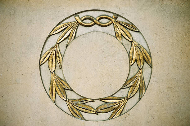 Laurel wreath in gold on stone wall of outer facade of London building