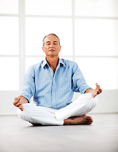 istock Mature businessman meditating at home. 185244398