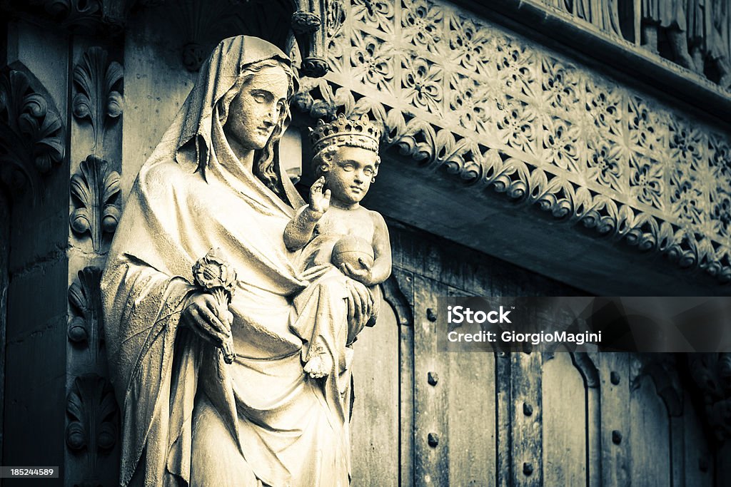 Virgin Mary with Baby at Westminster Abbey, London Ancient statue on the exterior of the Westminster Abbey in London, UK. Adult Stock Photo