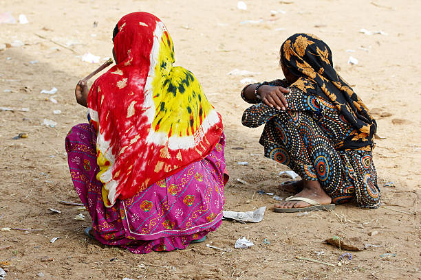 istock Two indian women squatting 185244658